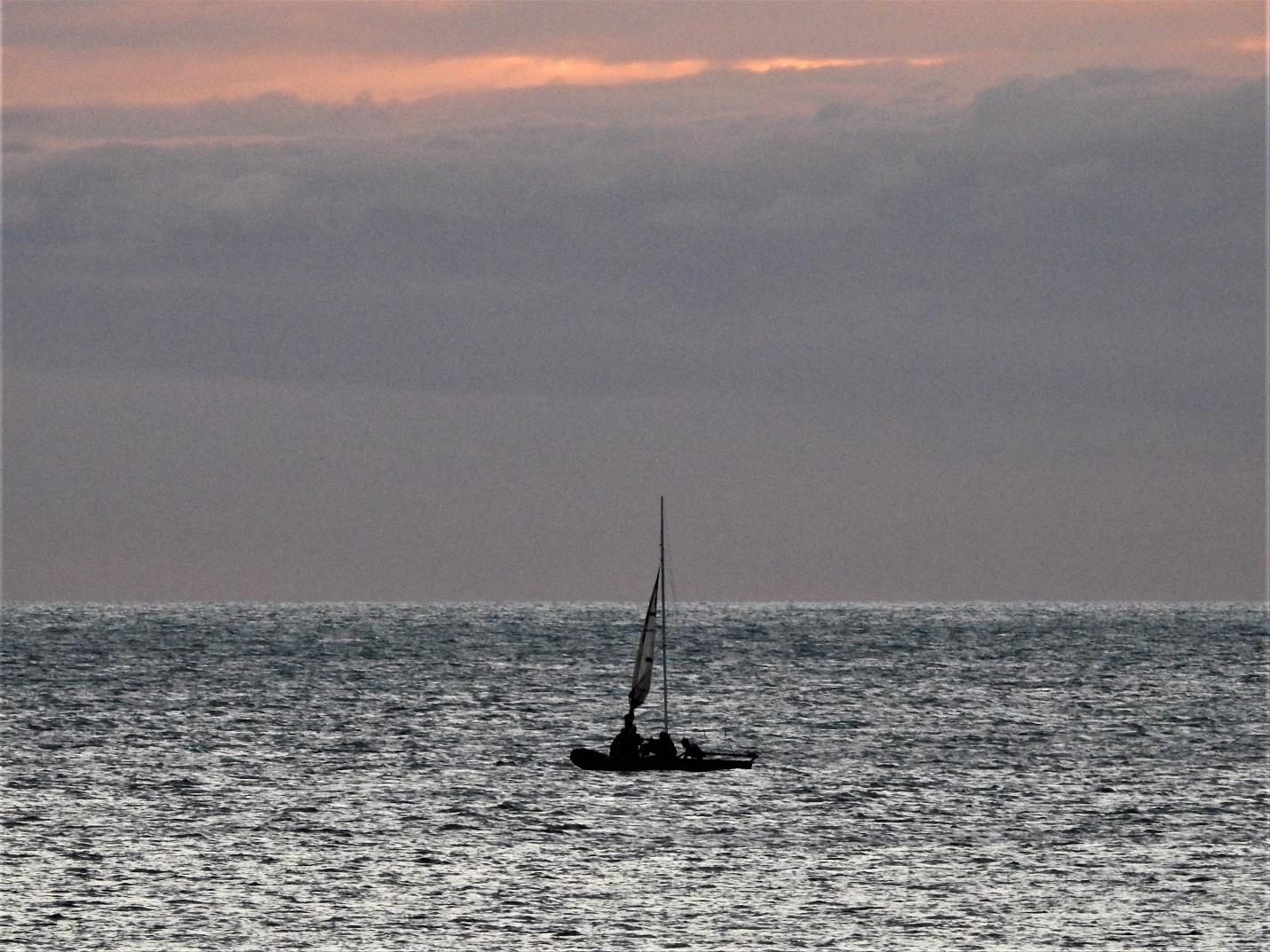 A small boat in a large body of waterDescription automatically generated