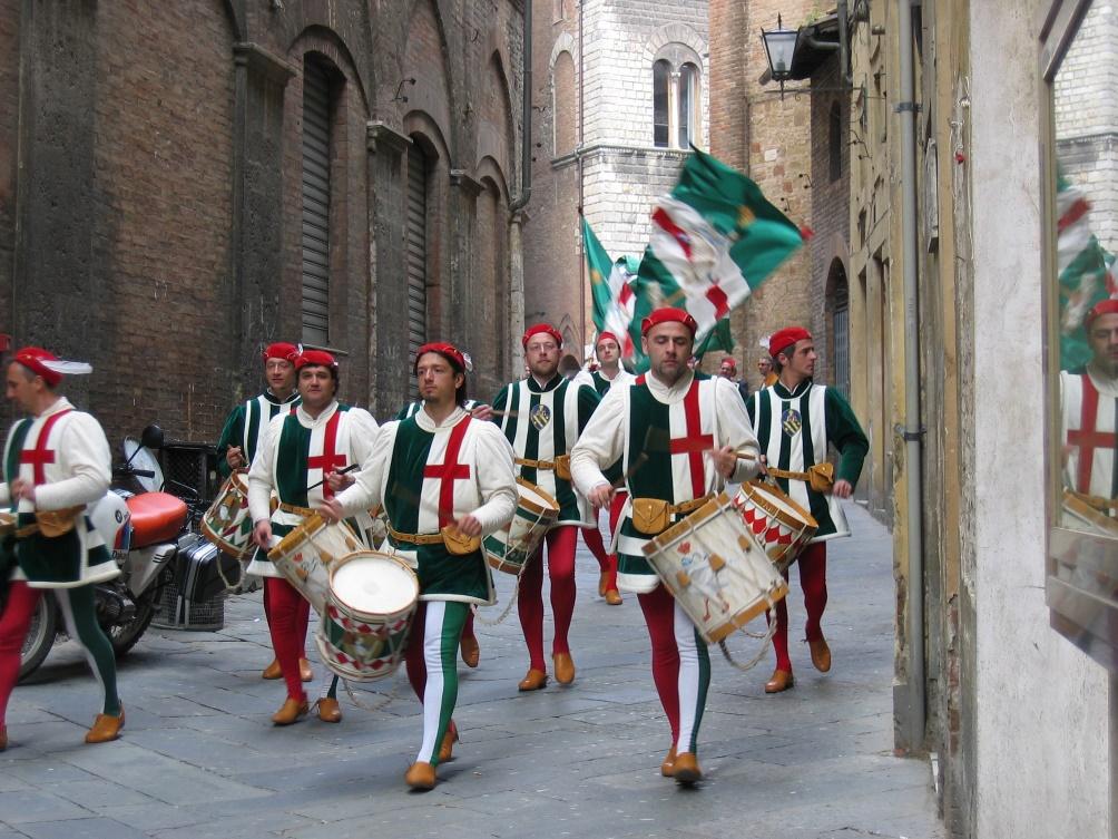 A group of people walking down a streetDescription automatically generated