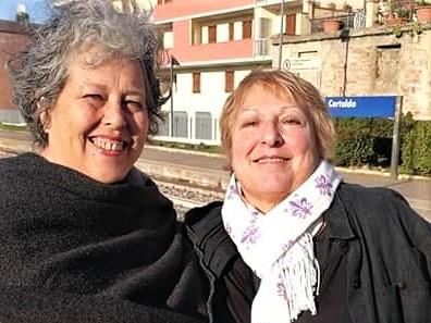 Two women smiling for a pictureAI-generated content may be incorrect.