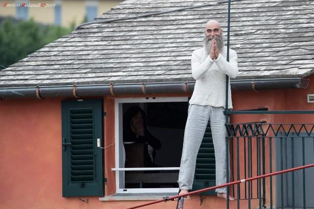A person standing in front of a buildingDescription automatically generated