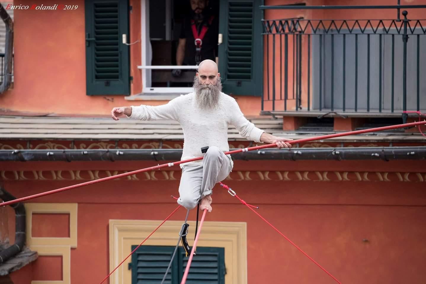A person standing in front of a buildingDescription automatically generated