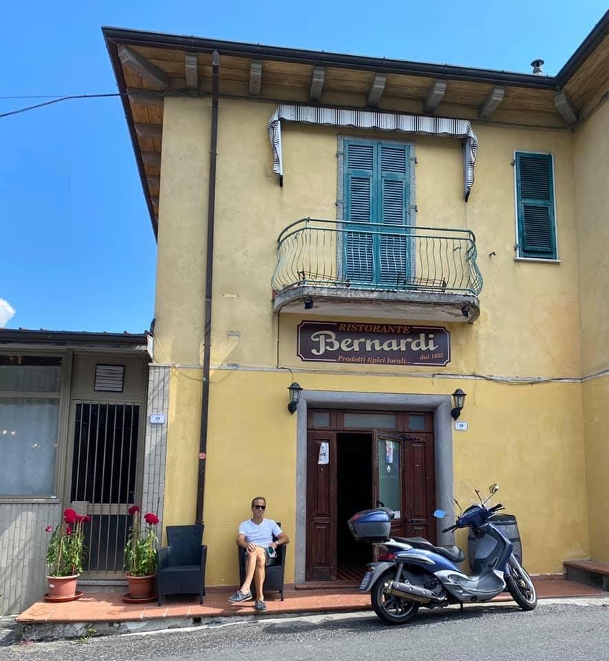 A scooter parked in front of a buildingDescription automatically generated