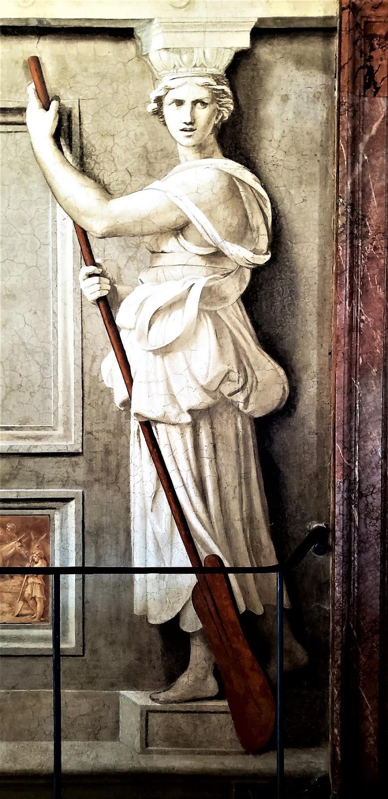 A statue of a person holding a staffDescription automatically generated with medium confidence