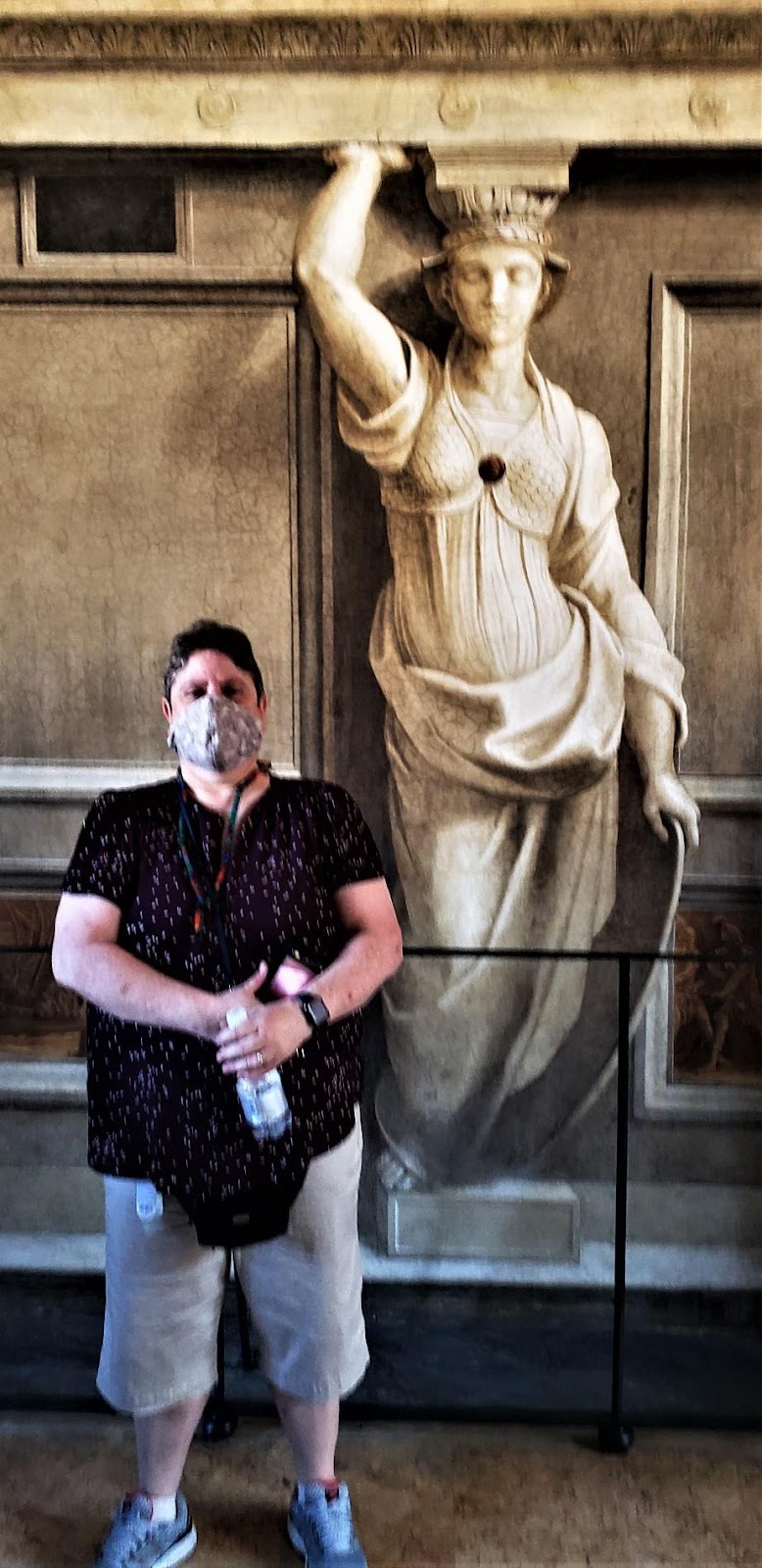 A person posing next to a statueDescription automatically generated