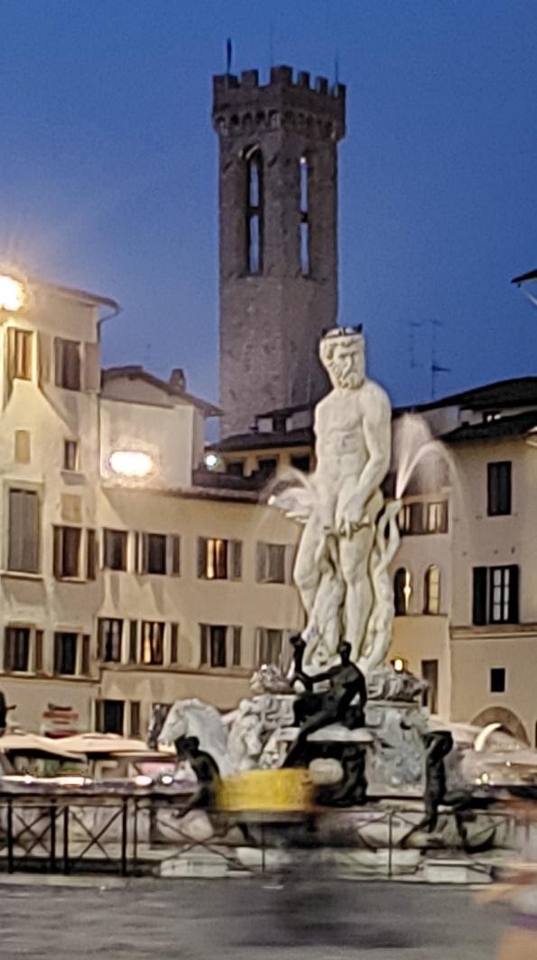A statue of a person in front of a buildingDescription automatically generated with low confidence