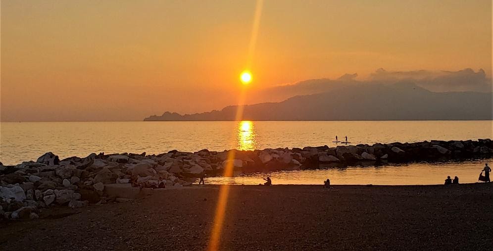 A sunset over a beachDescription automatically generated with low confidence