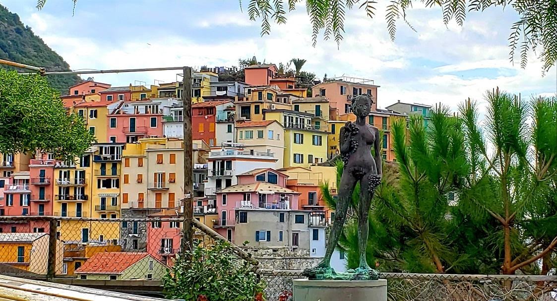 A statue of a person in front of a cityDescription automatically generated with medium confidence