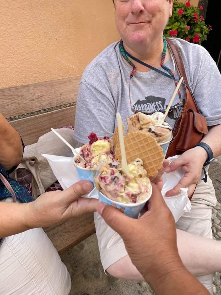 A person holding a bowl of ice creamDescription automatically generated with medium confidence