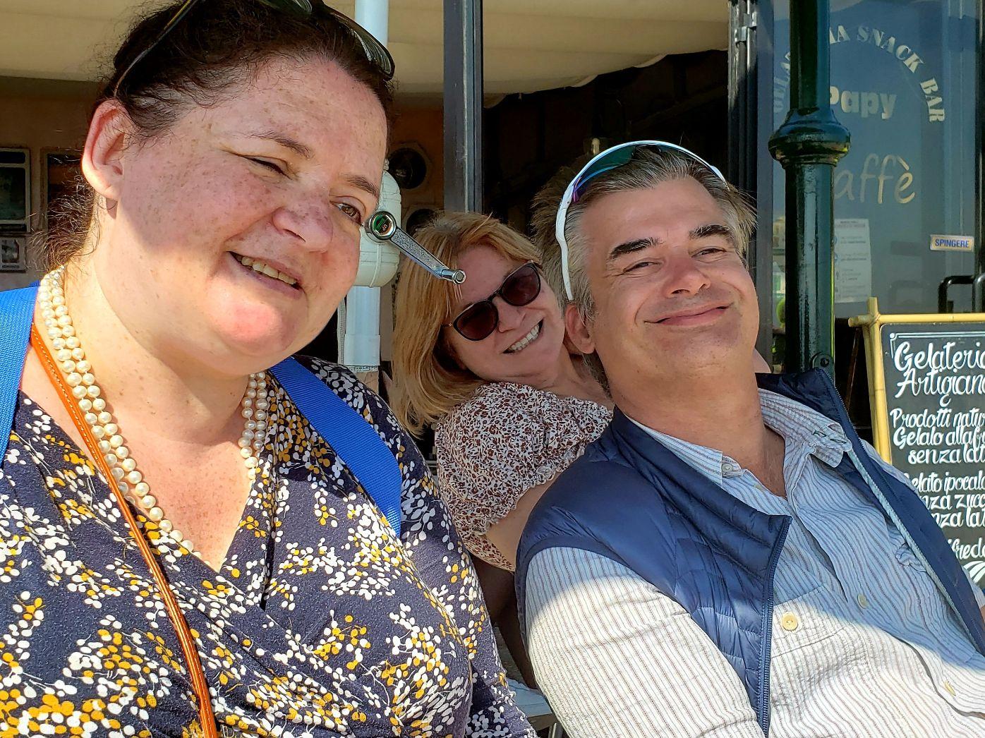 A group of people smilingDescription automatically generated with low confidence