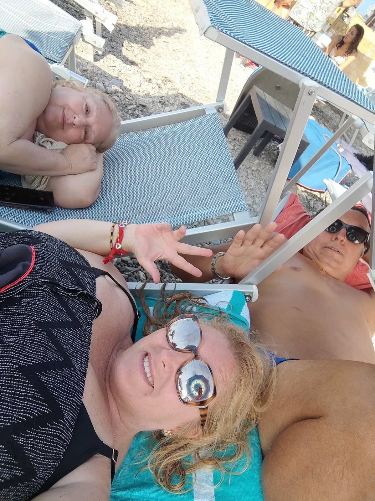 A group of people lying on a deckDescription automatically generated with low confidence