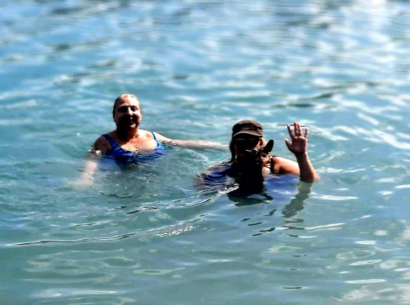 A person and person in the waterDescription automatically generated with medium confidence
