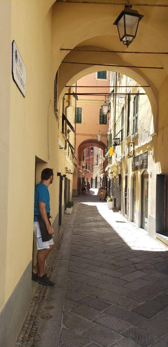 A person standing in a narrow alleyDescription automatically generated with low confidence