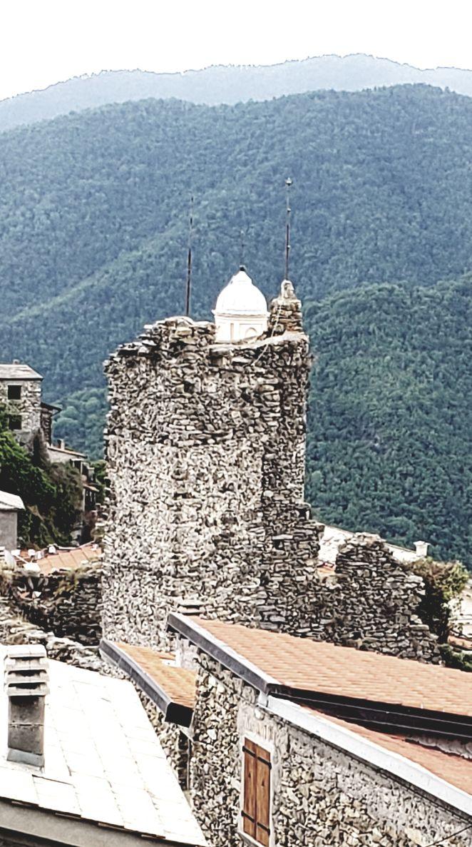 A picture containing mountain, outdoor, stone, roofDescription automatically generated