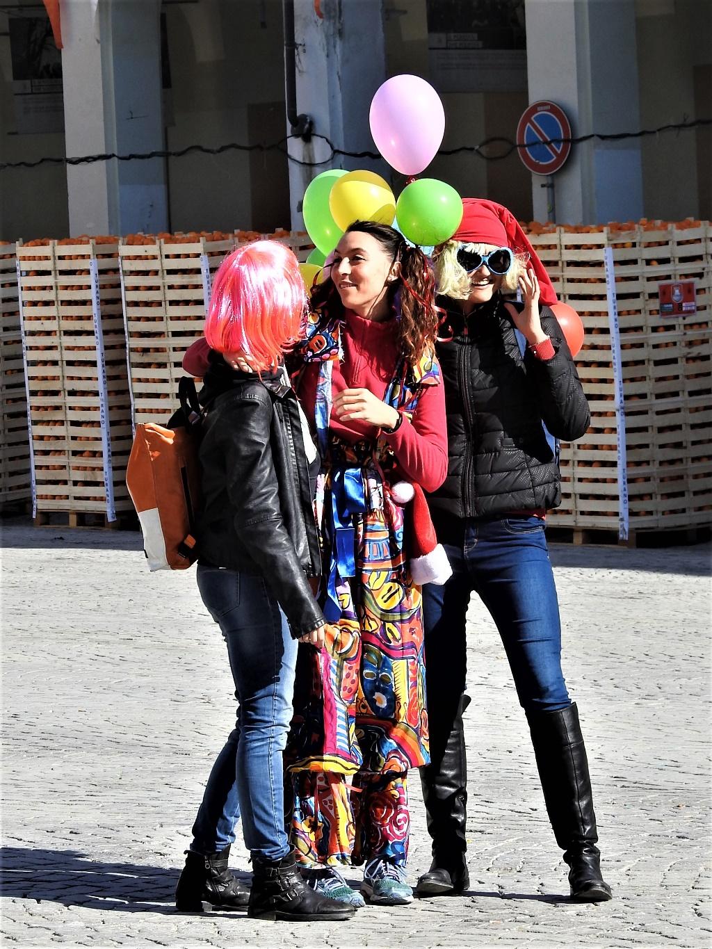 A group of people holding balloonsDescription automatically generated with medium confidence