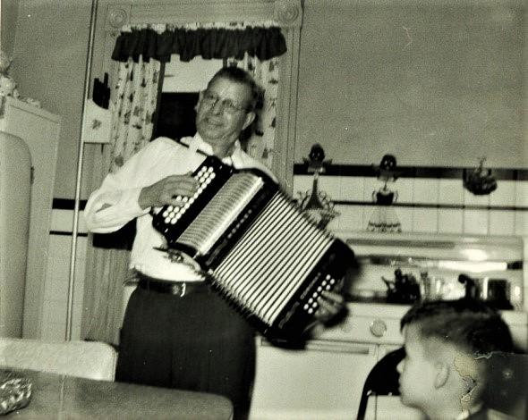 A person playing an accordionDescription automatically generated