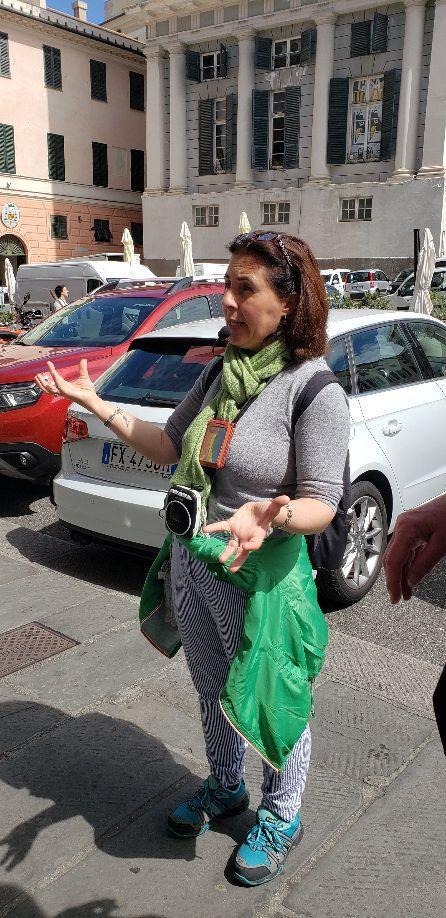 A person standing on a sidewalk with her hands outDescription automatically generated with low confidence