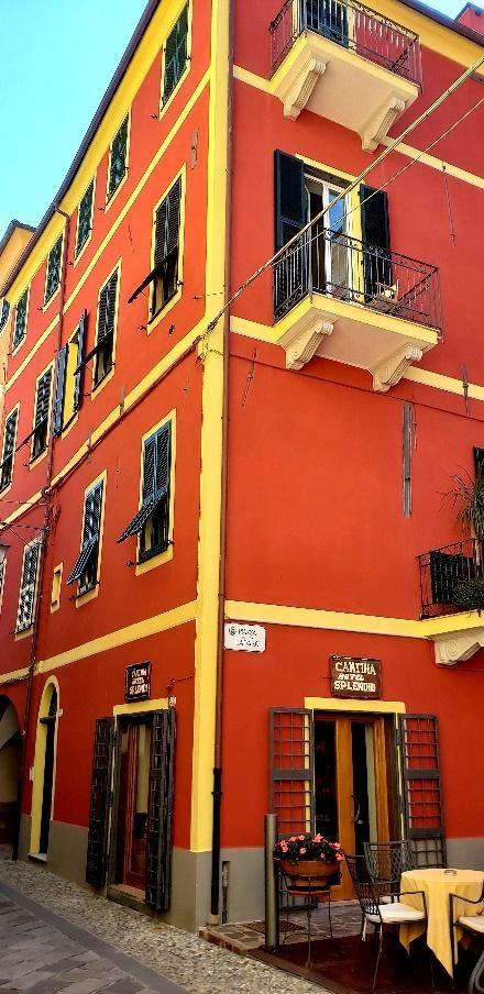 A red building with yellow trimDescription automatically generated with low confidence