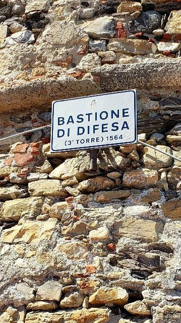 A sign on a stone wallDescription automatically generated with medium confidence