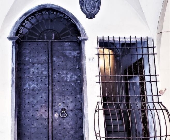 A picture containing building, door, home door, ironDescription automatically generated