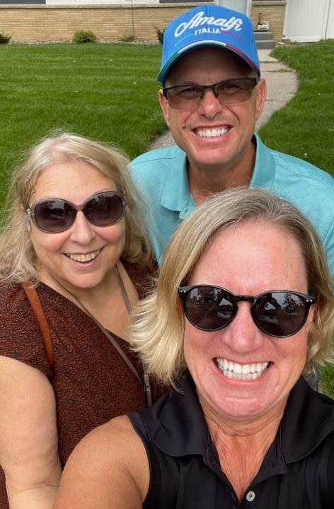 A group of people taking a selfieDescription automatically generated