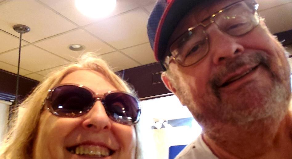 A person and person taking a selfieDescription automatically generated