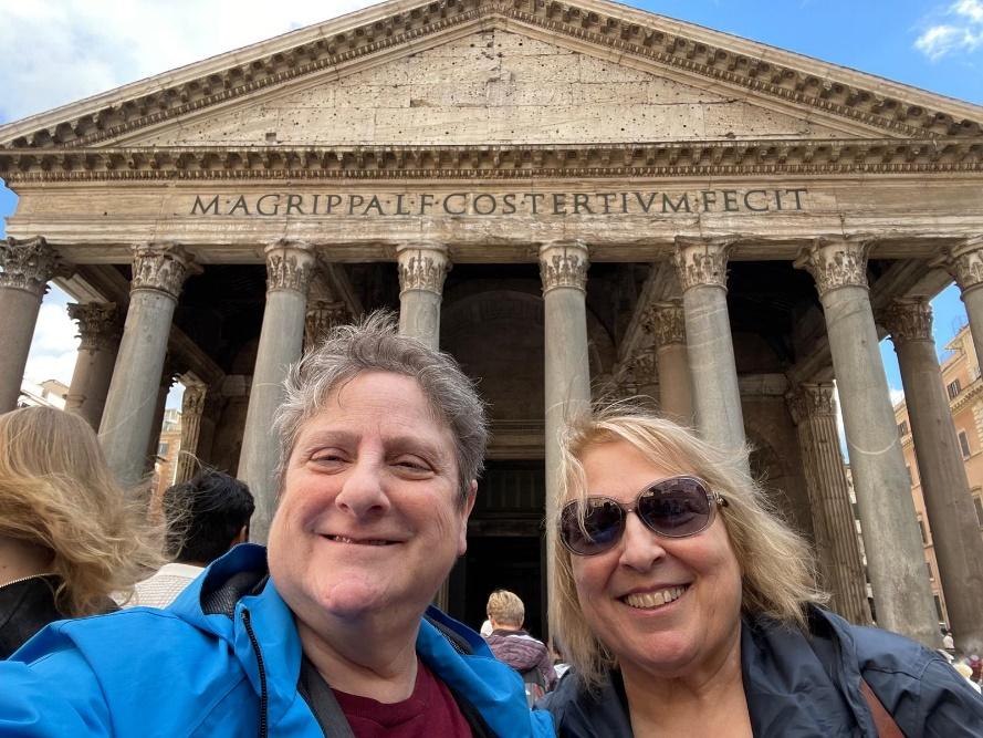 A group of people taking a selfie in front of Pantheon, RomeDescription automatically generated