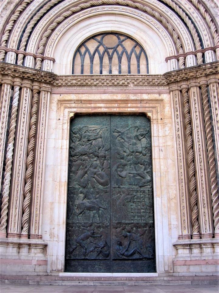A large metal door with carvingsAI-generated content may be incorrect.