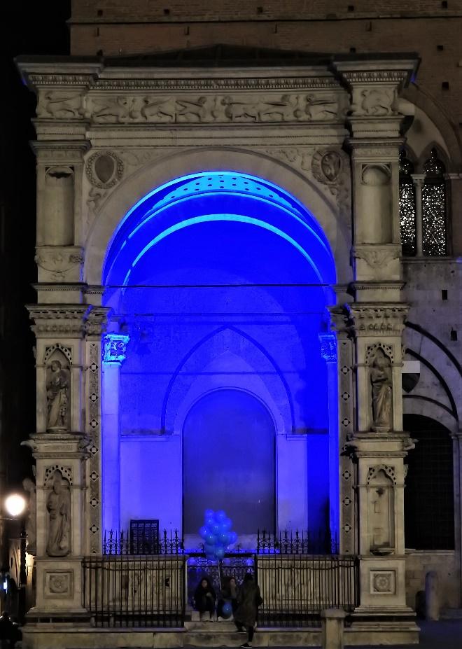 A blue lit archway with a statue in front of itAI-generated content may be incorrect.