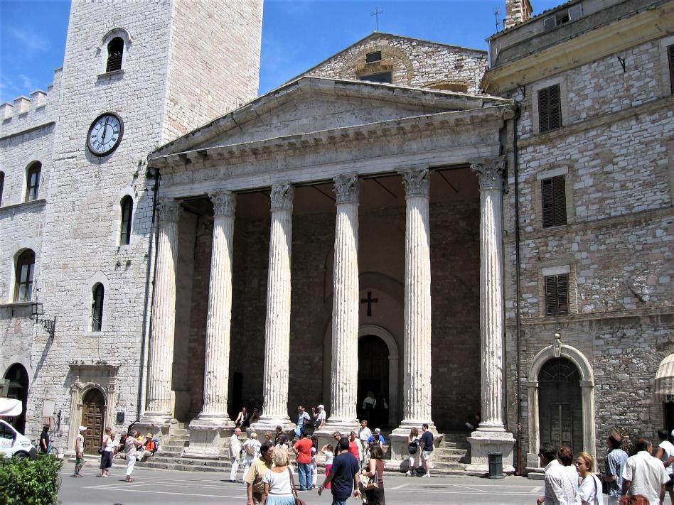 A group of people walking in front of a buildingAI-generated content may be incorrect.