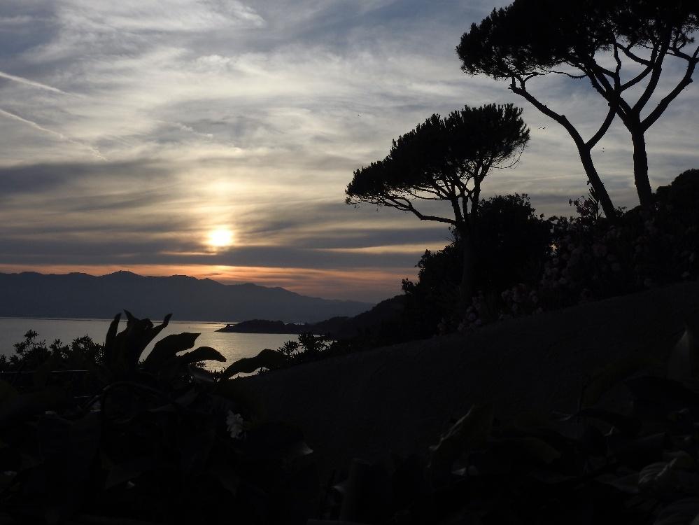 A sunset over a body of waterAI-generated content may be incorrect.